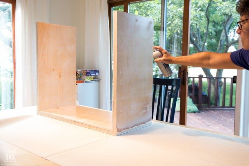 spray plywood diy console table with spray adhesive to secure fabric