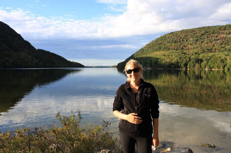 pregnant woman in acadia national park on babymoon