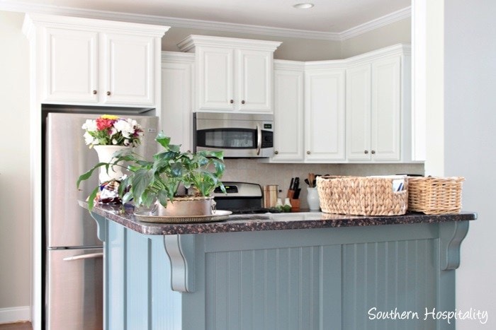 gray island and white upper cabinets painted in benjamin moore cabinet paint by southern hospitality blog