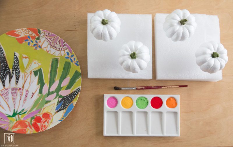 color palette for non traditional halloween tablescape featuring colorful pumpkins of pink, yellow, green, red, and orange