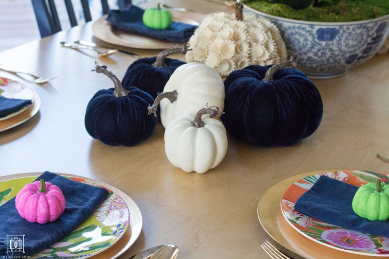 navy and white pumpkins on colorful pumpkin tablescape of multicolored pumpkins for fall decor