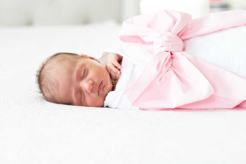 newborn girl with swaddle