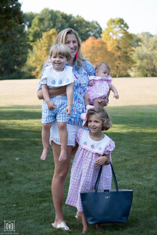 happy busy family with mom of three holding three kids