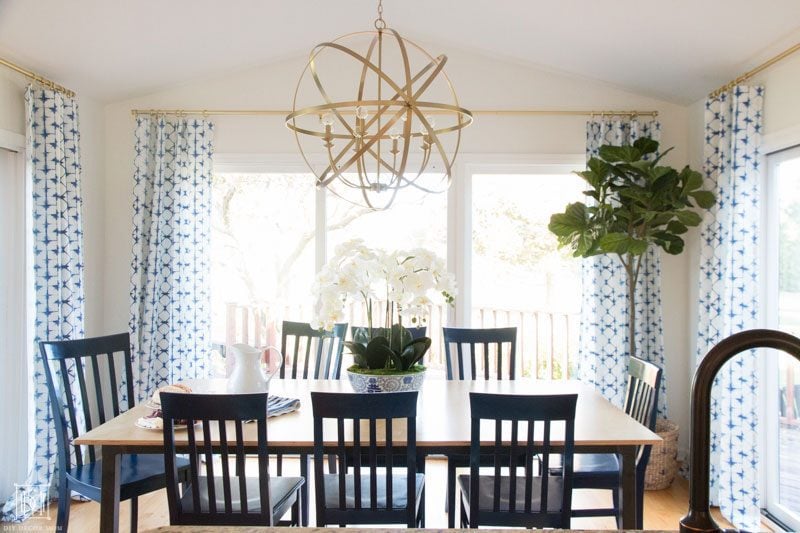 breakfast room with gold chandelier and sliding doors with curtains