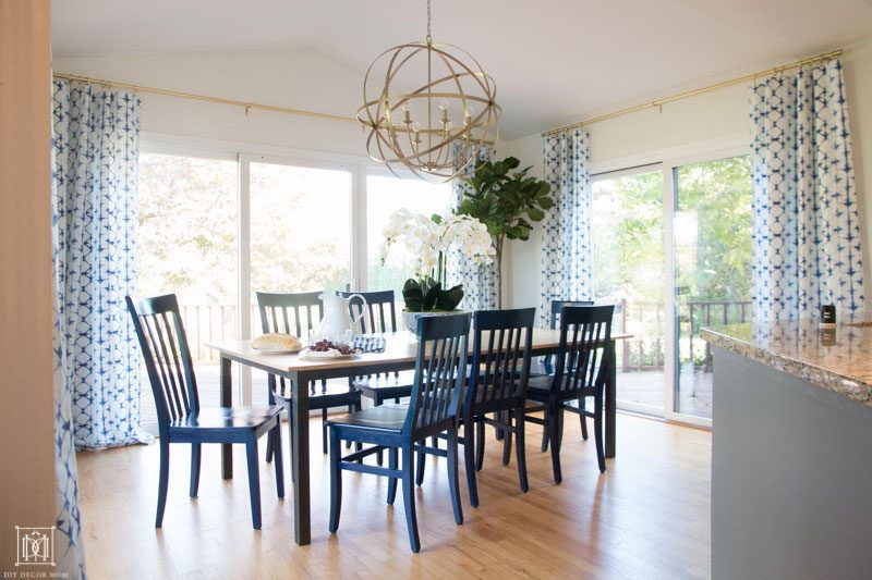 gold chandelier and kitchen breakfast table with blue dining chairs