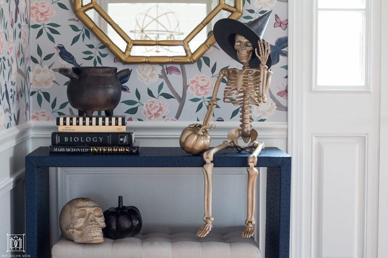 gold halloween decor in front hall with chinoiserie wallpaper