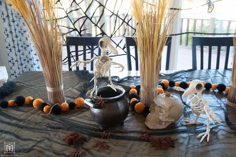 halloween table decor ideas with skeletons spiders and skulls