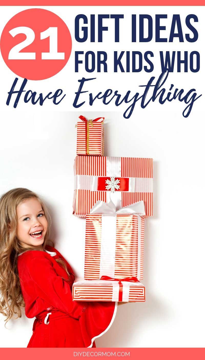 girl holding christmas gifts- gift guide ideas for kids who have everything