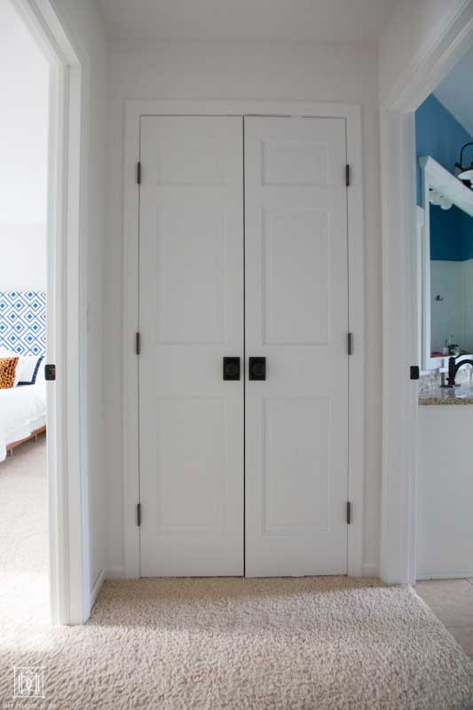 white hallway doors of linen closet