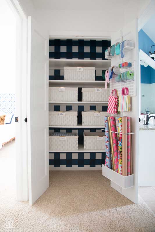 how to organize a linen closet- blue and white linen closet with white baskets