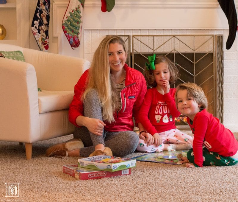 family playing board games in front of the fire