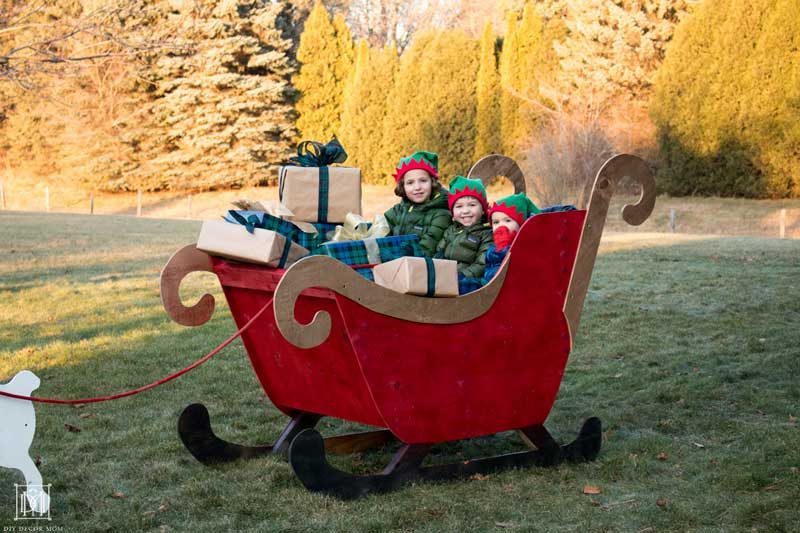 kids in wooden diy sleigh