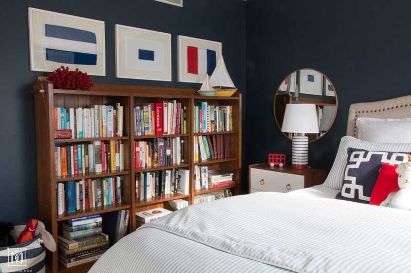 nautical bedroom for a little boy with navy walls and bookcase