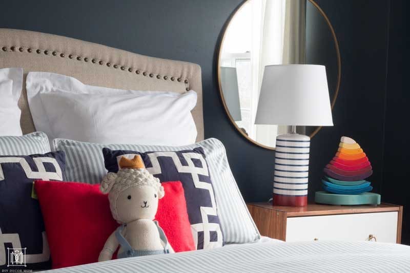 blue and white striped duvet on bed with stuffed animal in nautical bedroom