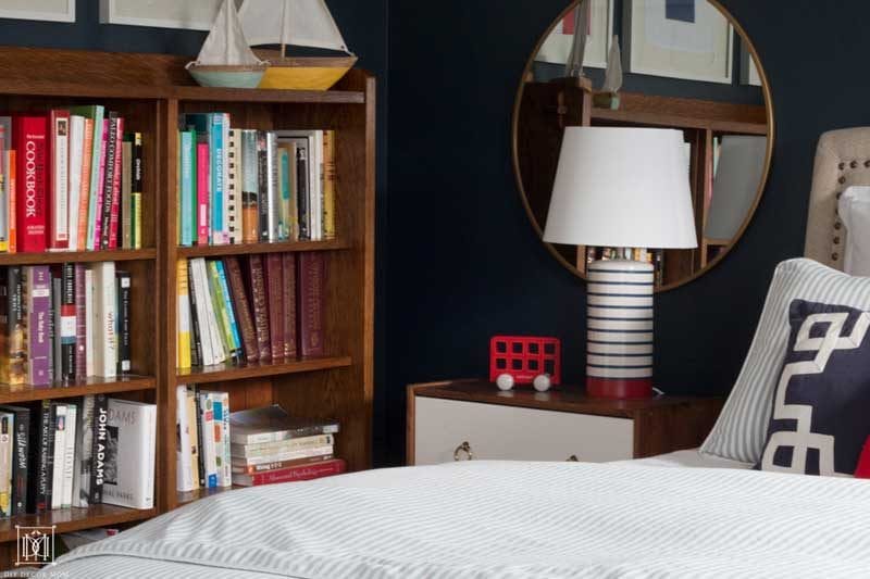 nautical themed bedroom with bookcase and boats