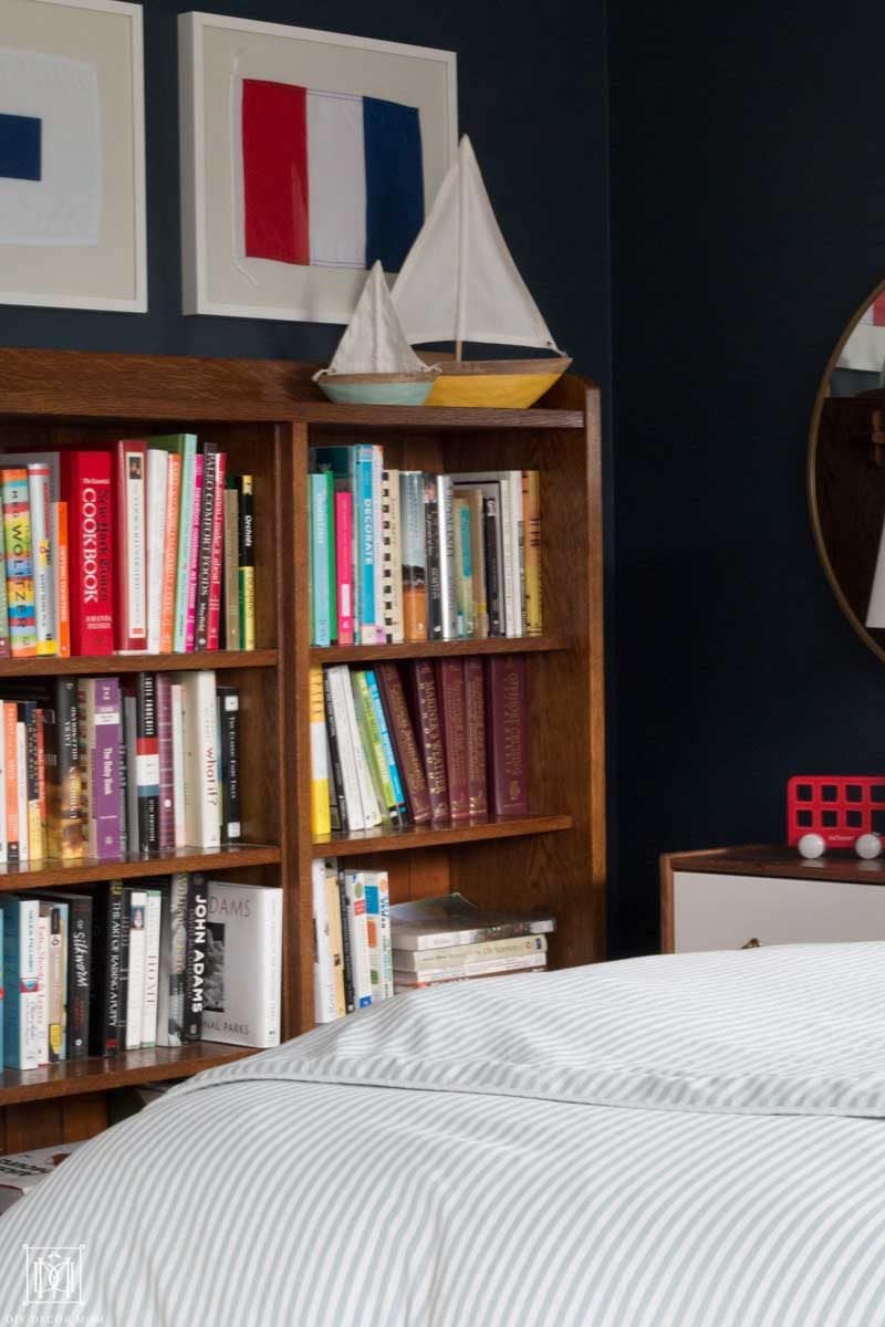 nautical bedroom decor vignette of bookcase with mini boats