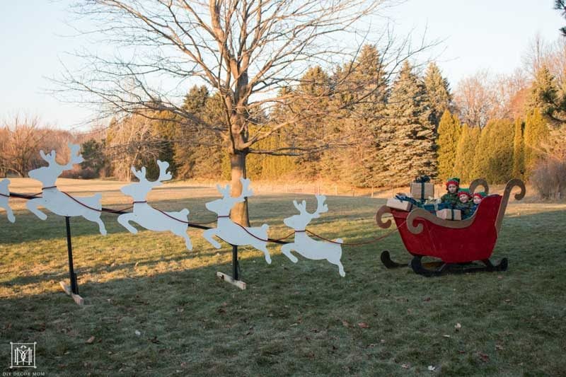 plywood reindeer on stand with santa sleigh