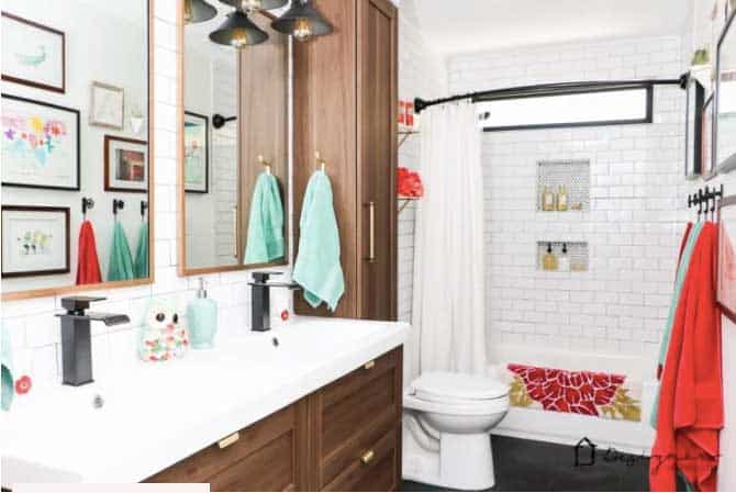 shared girls bathroom with wood cabinets and subway tile