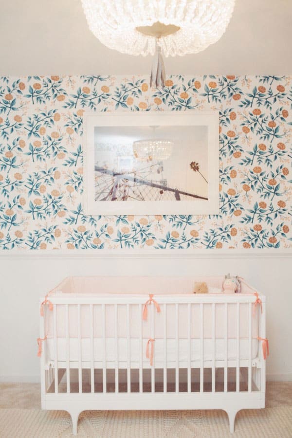 white crib with wallpaper in girls nursery by Comfy Cozy Couture