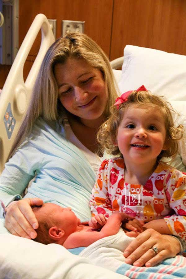 big sister and sibling meet for first time at hospital--see tips to help toddlers adjust to new baby