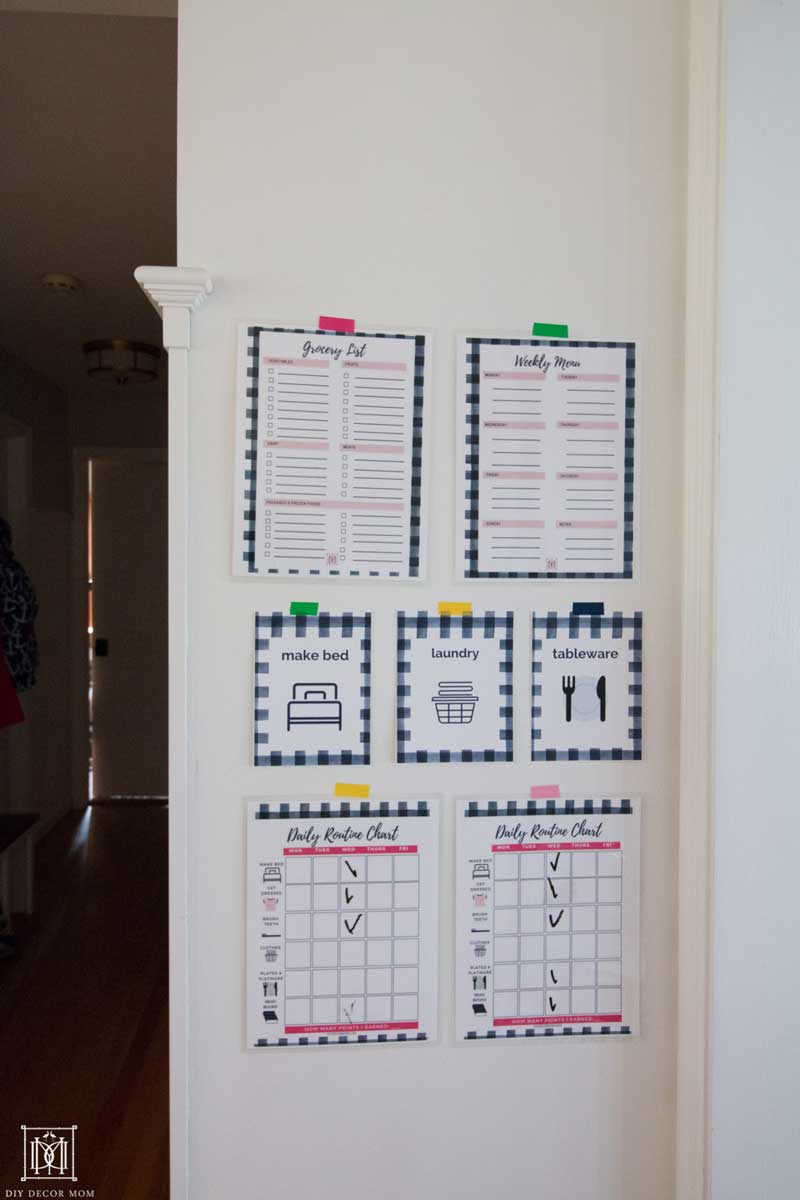 grocery list and daily chores printable for family on family command center on white wall