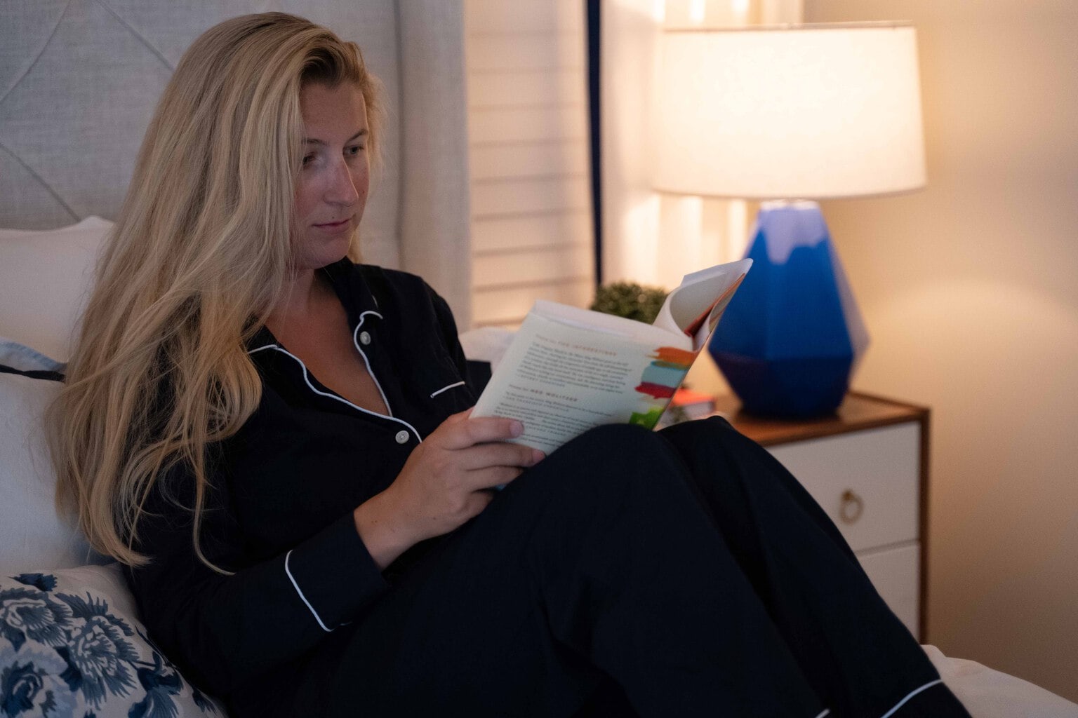 woman reading in comfy cozy relaxing bedroom