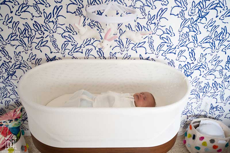 baby sleeping in a snoo smart sleeper in girls nursery