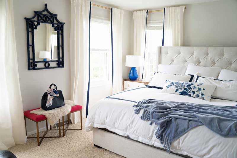 neutral master bedroom with blue and white accents