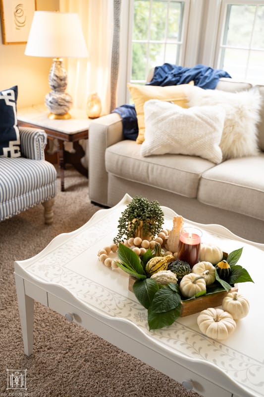 embracing hygge in your home and upping your cozy factor with soft pillows, candles, warm lights, and natural textures