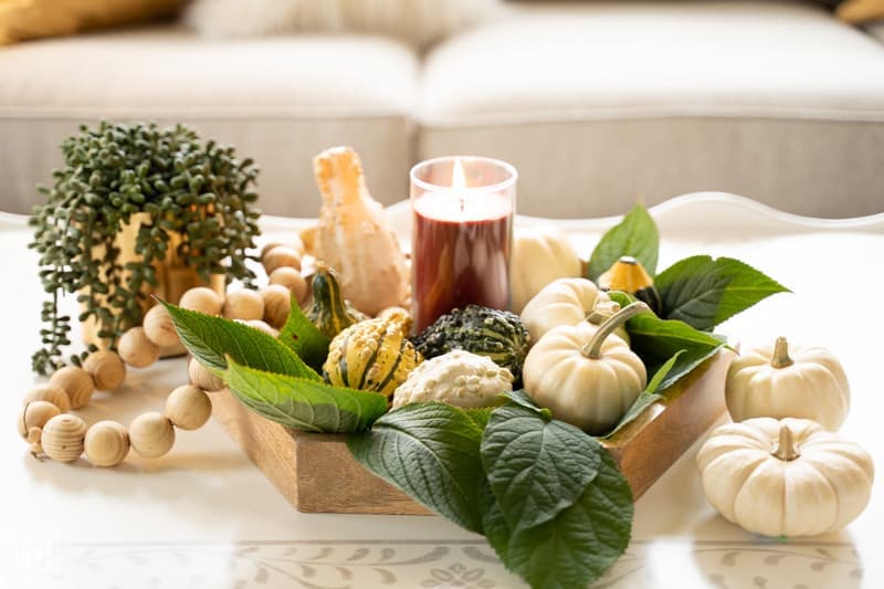 hygge in your home: picture of tray with fresh gourds and lighted candle