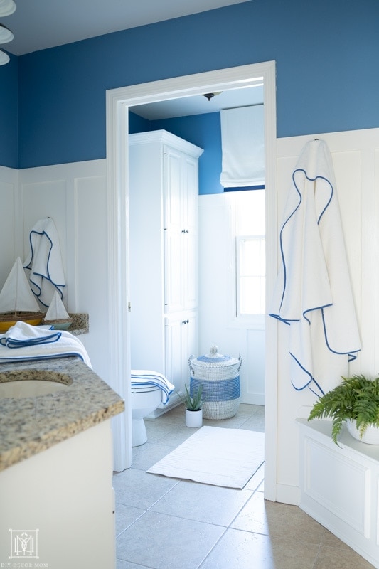 blue and white kids bathroom with new blue towels