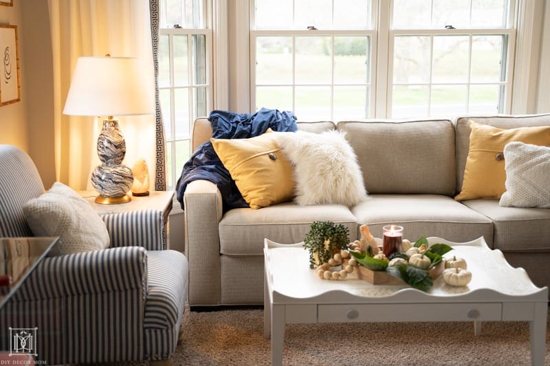 how to make your house have more hygge--light lamps, light candles, use soft textures and pillows