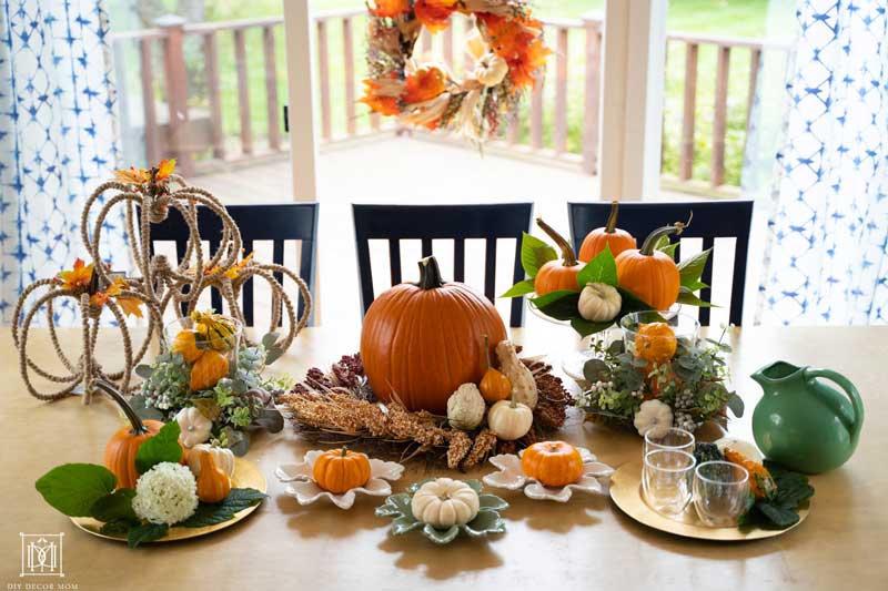 beautiful fall tablescape with pumpkins gourds and fall decorations