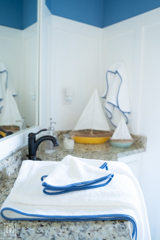 beautiful blue and white bathroom with white board and batten and fresh white towels