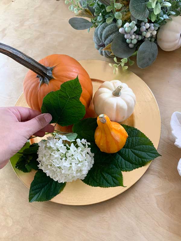 fresh leaves on a gold charger for fall table decorations