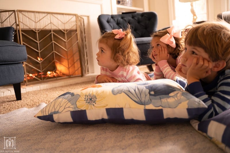 kids cozy by the fire watching a movie on a family movie night