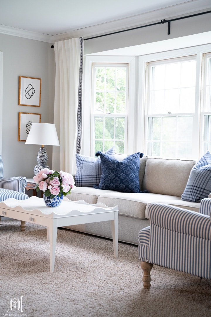 light gray painted living room with blue pillows