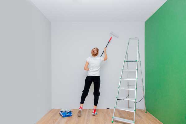 woman repainting a room before selling her house