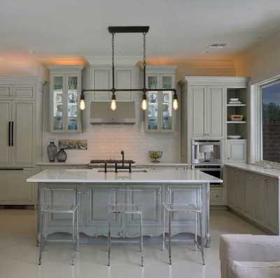 warm gray subtle painted cabinets in kitchen with lucite chairs and industrial light fixture