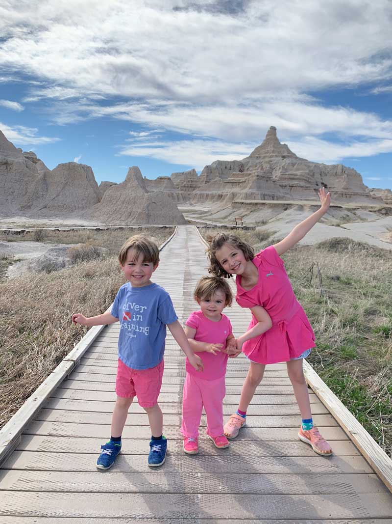 young kids posing in front of badlands national park