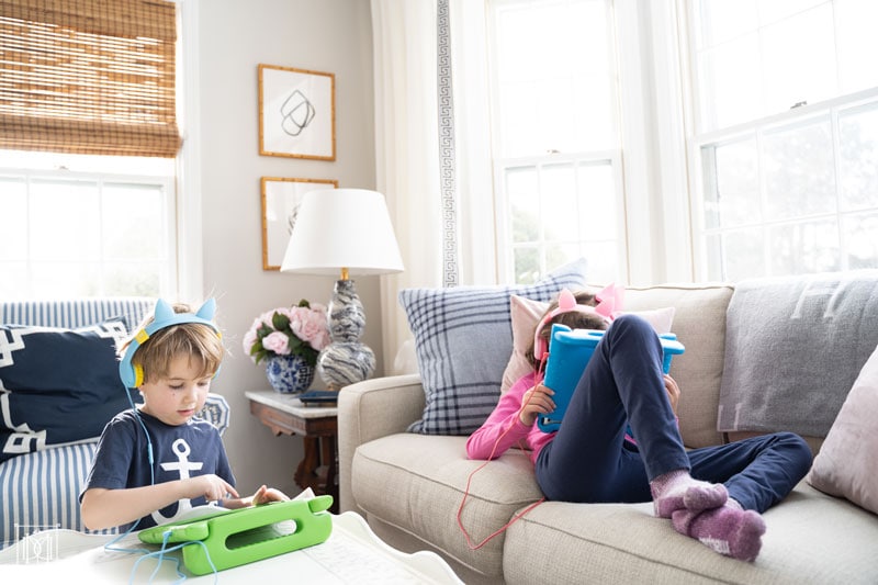 two kids reading and playing on ipads--see the best parents screen management for kids here