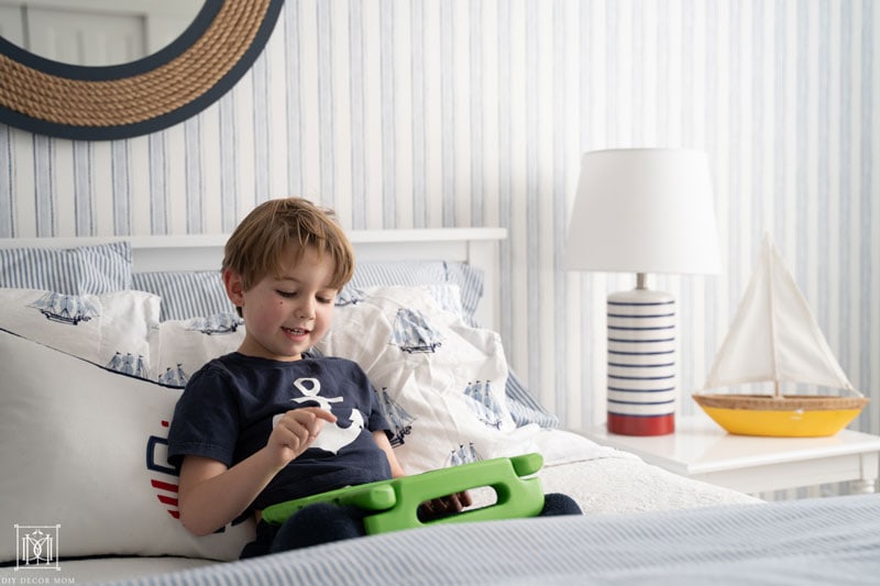 how to manage screentime with preschoolers and kids--boy playing on ipad in bed