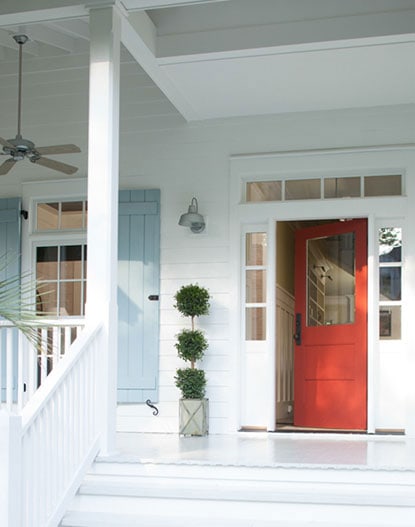 BM Raspberry Truffle front door with white siding and light blue shutters