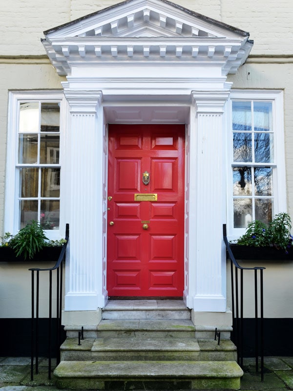 bright red front door with white columns