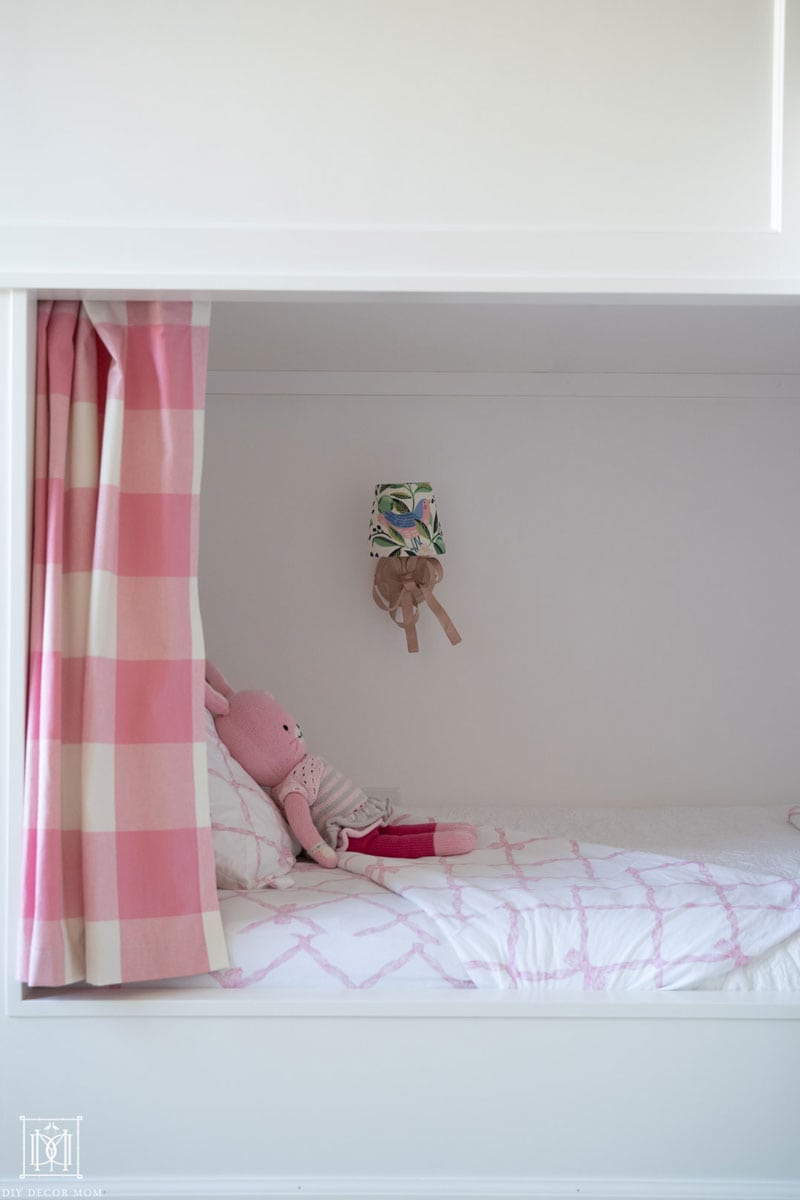 detail shot of white bunk bed with curtains