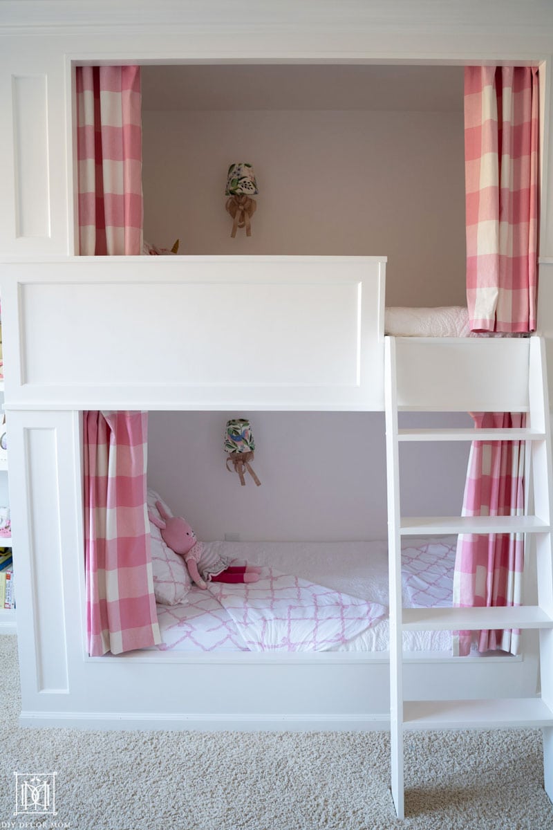 girls bunk room with built-in bunk beds and pink and white curtains made out of buffalo-check fabric