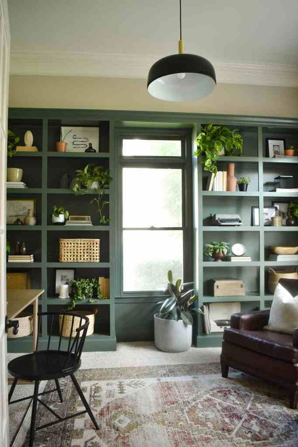 green painted bookshelves in home office