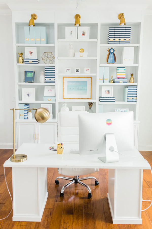 white at home office with white bookshelves- emily ley