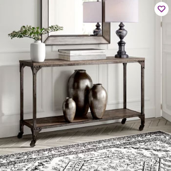 industrial console in entry with white walls and white trim and herringbone gray floors