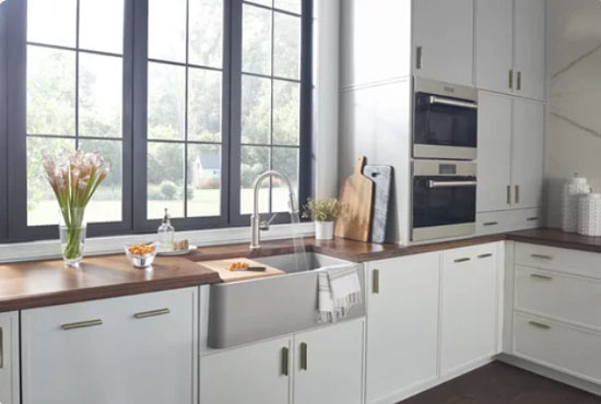 modern white kitchen cabinets with marble backsplash